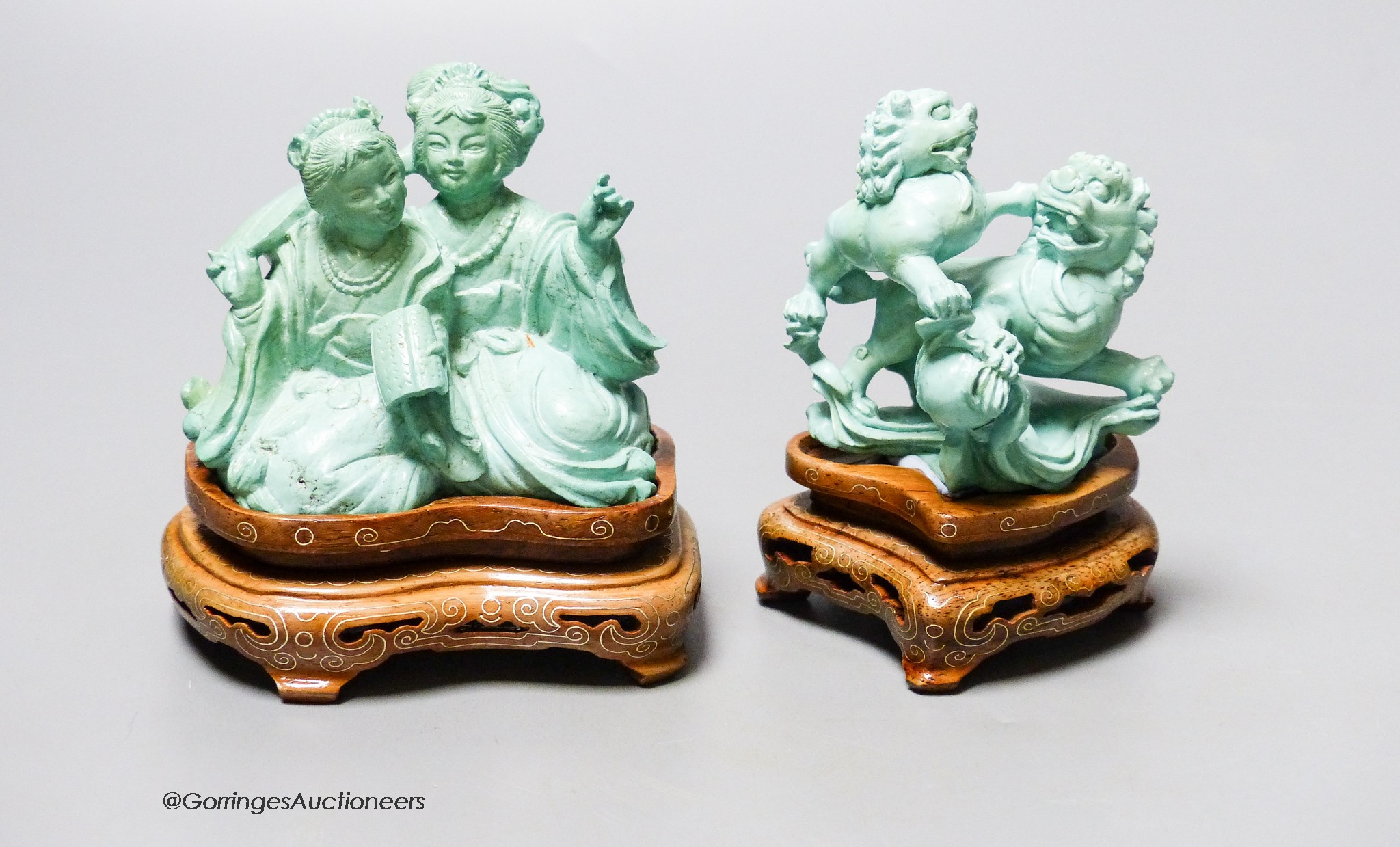 Two Chinese turquoise matrix groups of lion-dogs and of two kneeling ladies, mid 20th century, wood stands, height 9cm